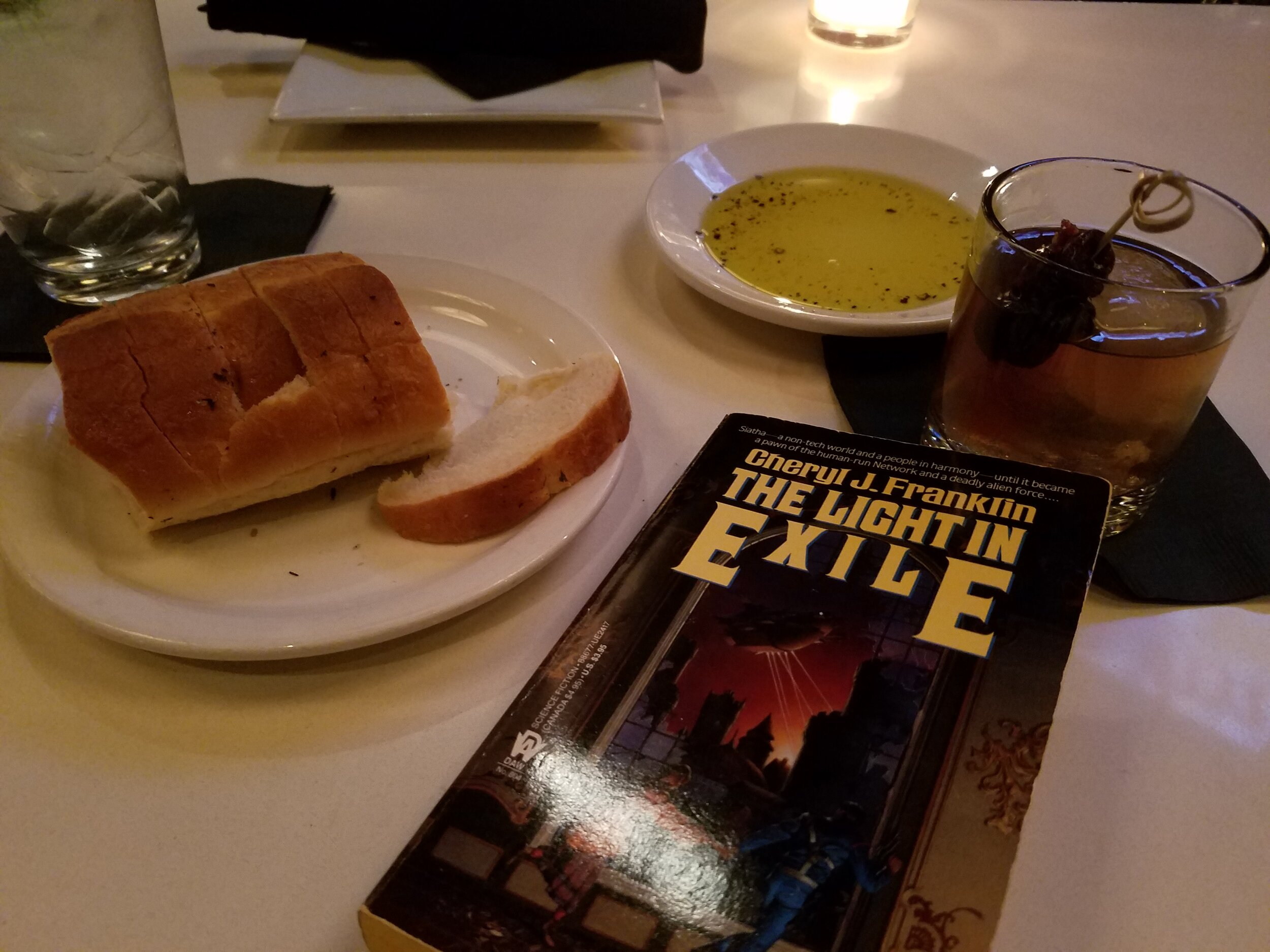 Reading The Light in Exile at the bar of an Italian restaurant
