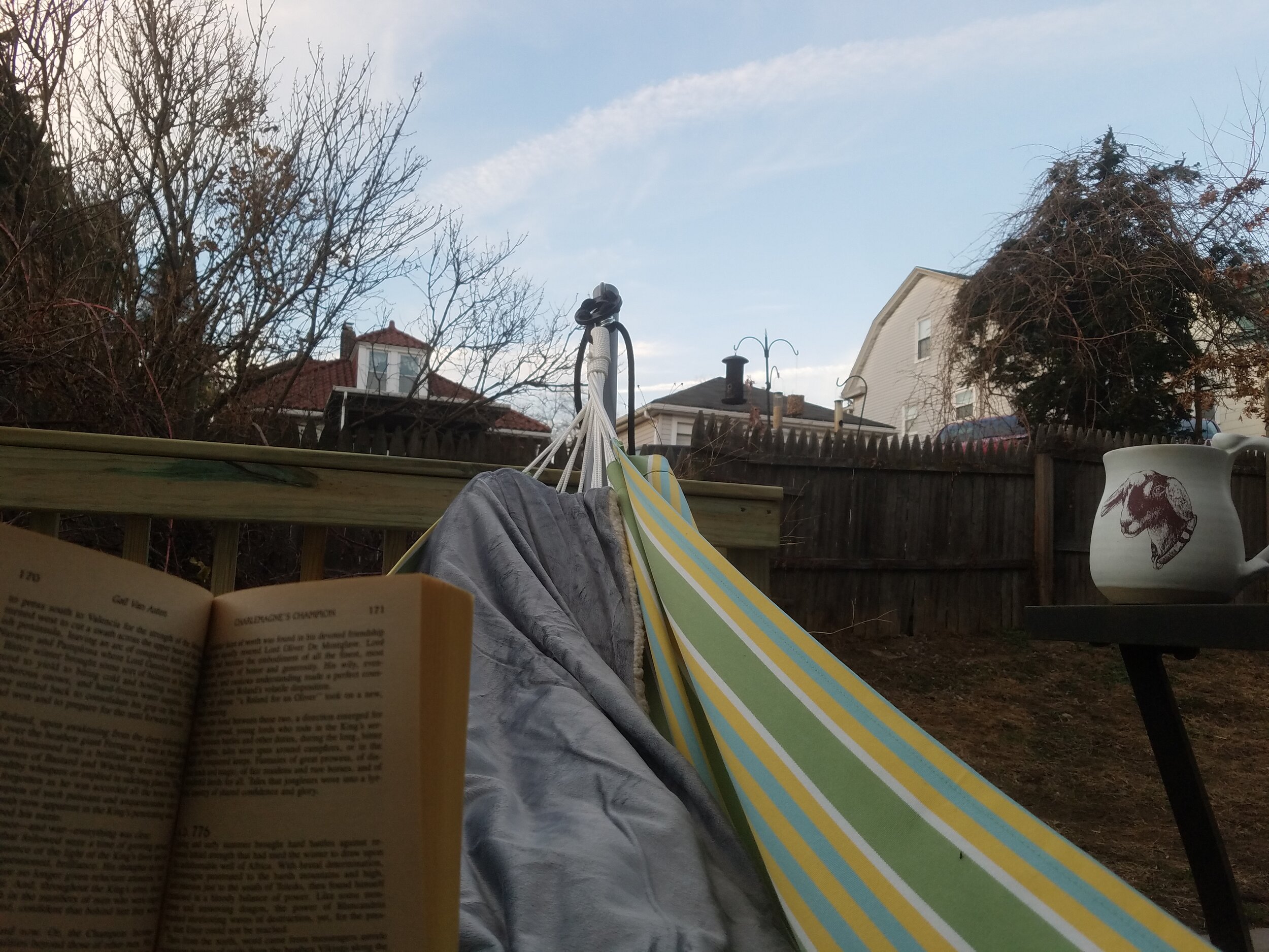 Reading in a hammock in December with a blanket and hot tea